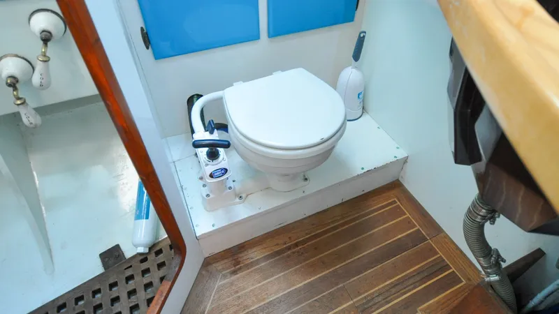Slide: The Image of 1987 Wittholtz/Luzier 49 | Destiny Marine toilet in 1987 Custom Wittholtz/Luzier Sloop/Cutter with wooden flooring. - 6319019