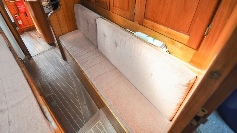 Slide: The Image of 1987 Wittholtz/Luzier 49 | Destiny Interior of 1987 Custom Wittholtz/Luzier Sloop/Cutter with wooden cabinetry and cushioned seating. - 6319028