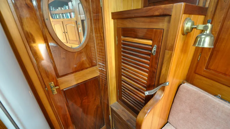 Slide: The Image of 1987 Wittholtz/Luzier 49 | Destiny Wooden interior of 1987 Custom Wittholtz/Luzier Sloop/Cutter with louvered cabinet and brass lamp. - 6319029