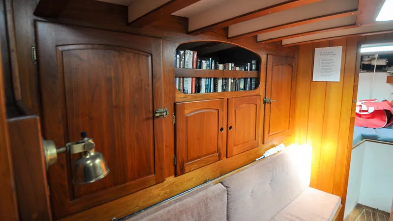 Slide: The Image of 1987 Wittholtz/Luzier 49 | Destiny Wooden interior of 1987 Custom Wittholtz/Luzier Sloop/Cutter with bookshelves and cozy seating. - 6319030