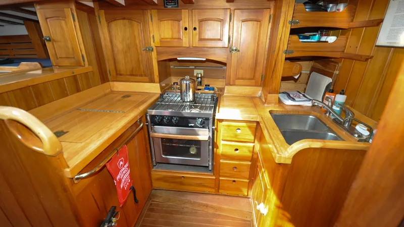 Slide: The Image of 1987 Wittholtz/Luzier 49 | Destiny Wooden galley kitchen in 1987 Custom Wittholtz/Luzier Sloop/Cutter with stove and sink. - 6319033