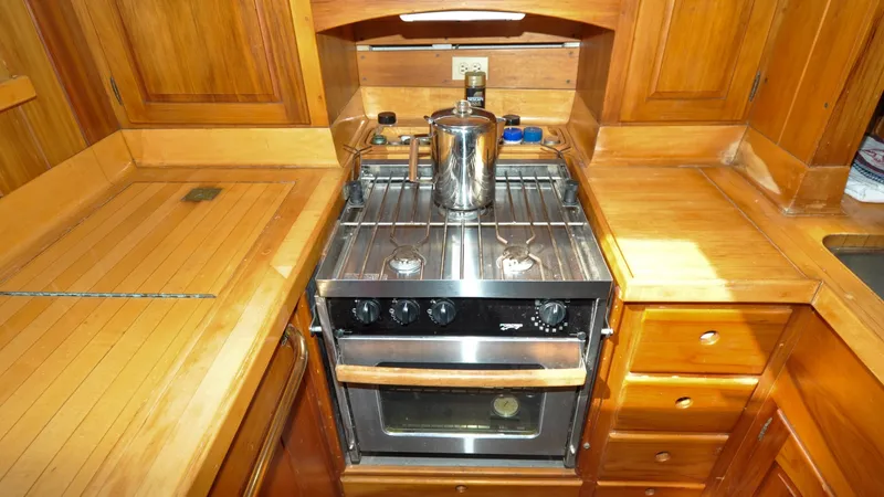 Slide: The Image of 1987 Wittholtz/Luzier 49 | Destiny Wooden yacht kitchen with stove, oven, and storage, Custom Wittholtz/Luzier Sloop/Cutter, 1987. - 6319036
