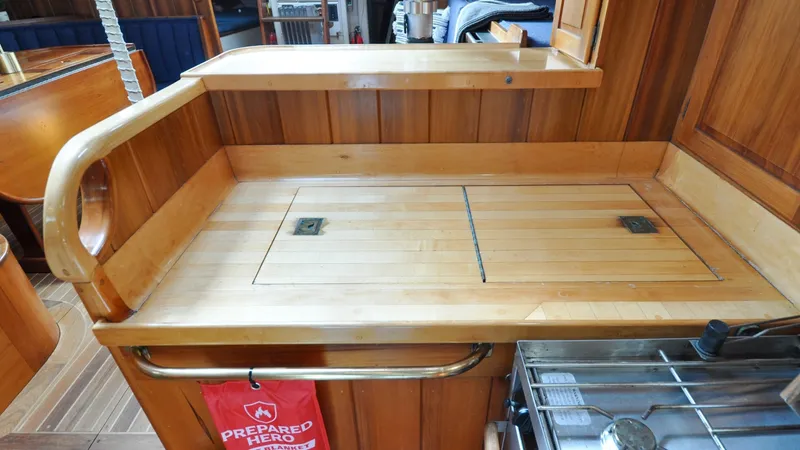 Slide: The Image of 1987 Wittholtz/Luzier 49 | Destiny Wooden interior of 1987 Custom Wittholtz/Luzier Sloop/Cutter with storage compartments and stove. - 6319037