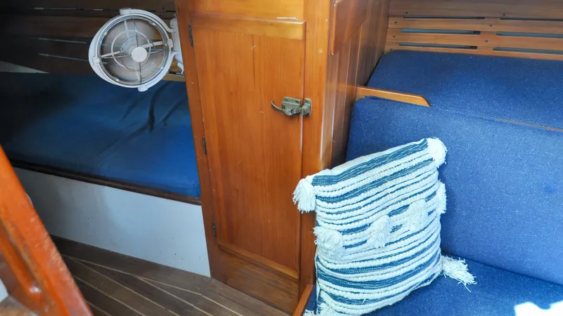 Slide: The Image of 1987 Wittholtz/Luzier 49 | Destiny Interior of 1987 Custom Wittholtz/Luzier Sloop/Cutter with blue cushions and striped pillow. - 6319044