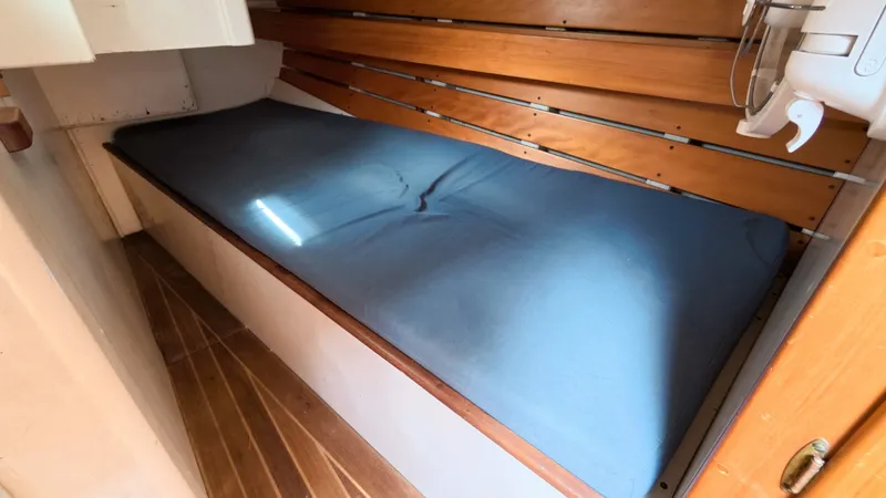 Slide: The Image of 1987 Wittholtz/Luzier 49 | Destiny Interior cabin of 1987 Custom Wittholtz/Luzier Sloop/Cutter with wooden paneling and blue mattress. - 6323968