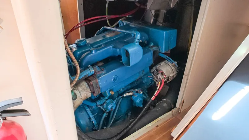 Slide: The Image of 1987 Wittholtz/Luzier 49 | Destiny Engine compartment of 1987 Custom Wittholtz/Luzier Sloop/Cutter, featuring a blue marine engine. - 6323967