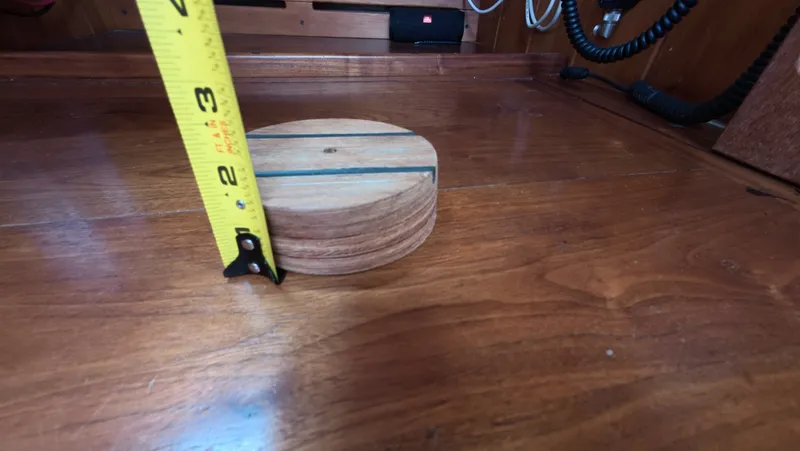 Slide: The Image of 1987 Wittholtz/Luzier 49 | Destiny Wooden surface with a round wooden object and a measuring tape, inside a 1987 Custom Wittholtz/Luzier Sloop/Cutter. - 6323969