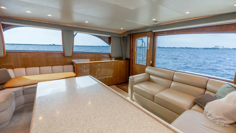 Slide: The Image of Spacious Salon with Panoramic Views The salon of the 2007 Viking 45 Convertible 'Desperado' offers a luxurious and inviting space with expansive windows providing stunning panoramic views. The plush seating and elegant wood finishes create a comfortable atmosphere, ideal for relaxation or e - 6394732