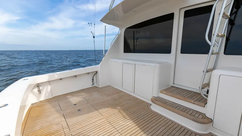 Slide: The Image of Spacious Teak Cockpit Area This image showcases the expansive teak cockpit area of the 2007 Viking 45 Convertible, Desperado. The cockpit is designed for both leisure and sport fishing, featuring ample space for movement and tackle storage. The clean lines and practical layout enha - 6394719