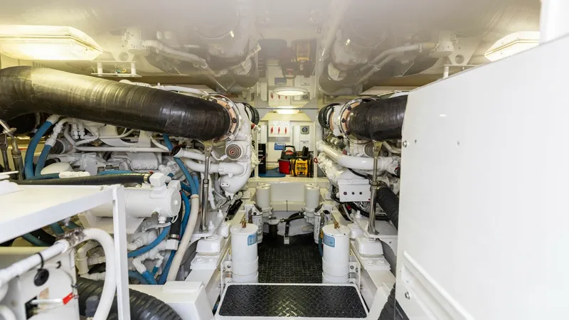 Slide: The Image of Engine Room and Mechanical Systems The engine room of the 2007 Viking 45 Convertible 'Desperado' features a well-organized layout with twin engines, showcasing robust mechanical systems. The space is designed for easy access and maintenance, with clearly labeled components and efficient us - 6394749