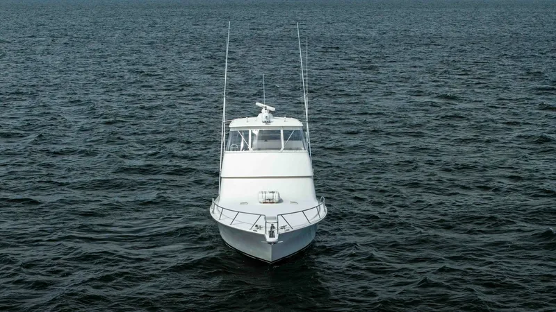 Slide: The Image of Bow View of Viking 45 Convertible This image captures the sleek and powerful bow of the 2007 Viking 45 Convertible, named Desperado. The clean lines and robust structure are designed for optimal performance on open waters. The expansive deck space and sturdy railings emphasize both safety - 6394754