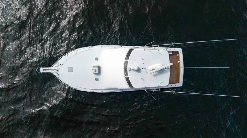 Slide: The Image of Aerial View of Flybridge This stunning aerial shot showcases the sleek design of the Viking 45 Convertible's flybridge. The spacious flybridge is equipped with advanced navigation equipment and offers a commanding view for optimal maneuverability. The vessel's clean lines and ele - 6394756
