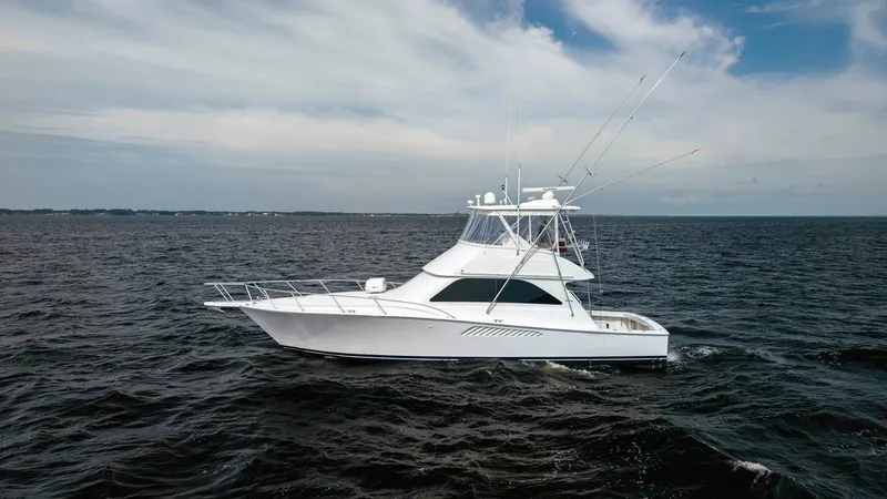 Slide: The Image of Side Profile of Viking 45 Convertible This image showcases the sleek side profile of the 2007 Viking 45 Convertible, named Desperado. The vessel's elegant lines and robust build are evident, highlighting Viking's renowned craftsmanship. The flybridge with its commanding view and the spacious - 6394757