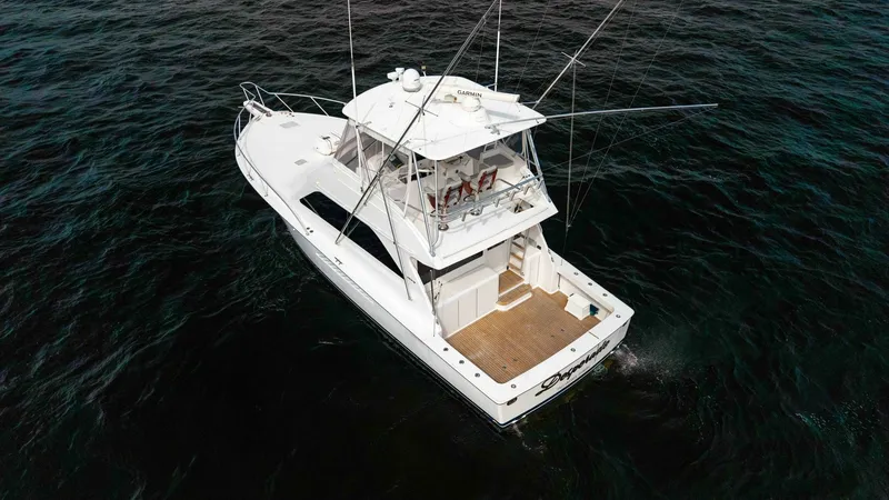 Slide: The Image of Aerial View of Flybridge and Cockpit This aerial shot showcases the Viking 45 Convertible's spacious flybridge and cockpit. The flybridge features ample seating and advanced navigation equipment, providing a commanding view for both leisure and fishing activities. The teak cockpit is designe - 6394759