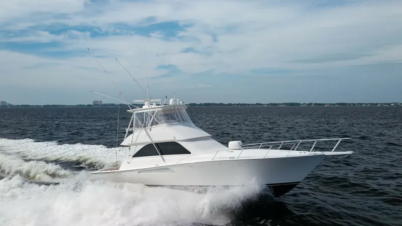 Slide: The Image of Dynamic Side Profile Underway The 2007 Viking 45 Convertible 'Desperado' showcases its sleek design and robust performance as it cuts through the water. The vessel features a spacious flybridge with a commanding view, and its aerodynamic hull ensures a smooth and efficient ride. Ideal - 6394761