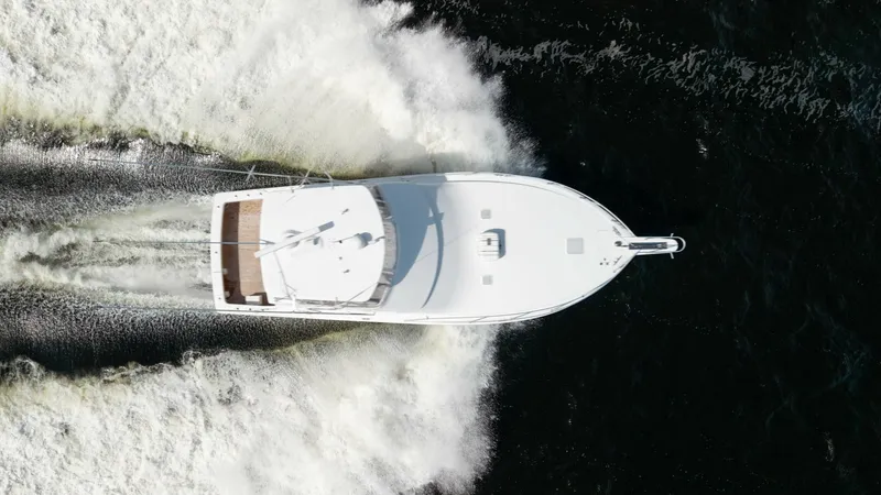 Slide: The Image of Aerial View of Viking 45 Convertible This striking aerial shot captures the Viking 45 Convertible slicing through the water with impressive power. The clean lines and spacious deck are showcased, highlighting the vessel's sleek design and robust performance. Ideal for both fishing and cruisi - 6394762