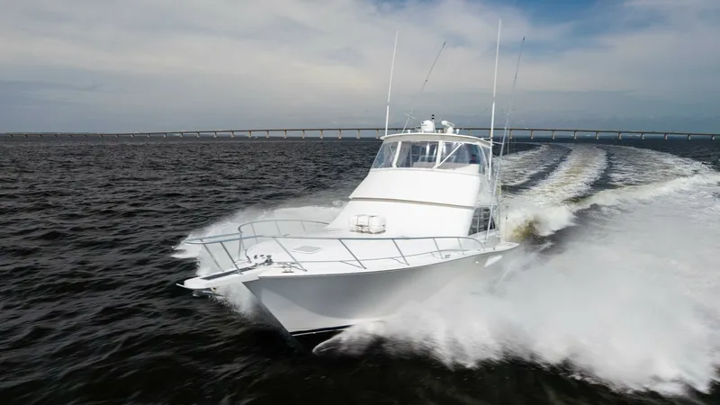 Slide: The Image of Dynamic Bow View in Motion The 2007 Viking 45 Convertible, Desperado, cuts powerfully through the open water, showcasing its sleek bow design and robust hull. The foredeck offers ample space, while the bridge provides excellent visibility, ideal for navigating challenging waters. T - 6394764