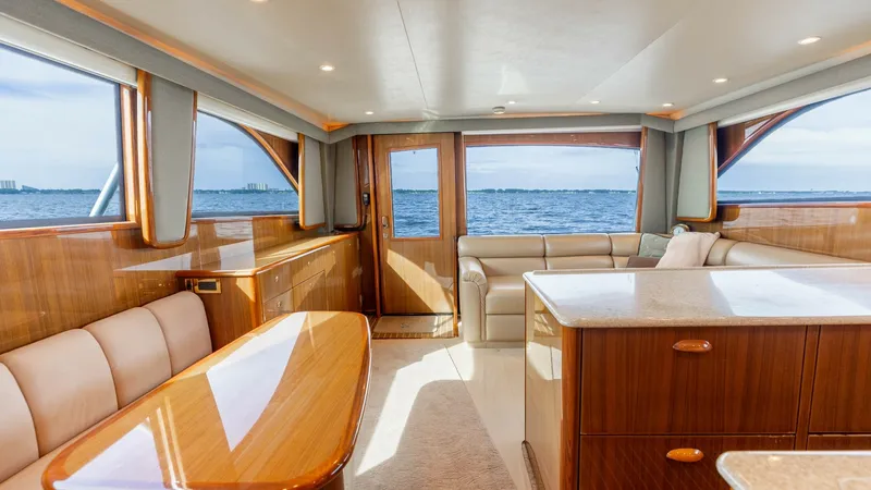 Slide: The Image of Main Salon with Ocean View This inviting main salon aboard the 2007 Viking 45 Convertible 'Desperado' boasts luxurious seating and a panoramic ocean view. The elegant wood finishes and plush upholstery create a warm and sophisticated ambiance. Natural light floods the space through - 6394721