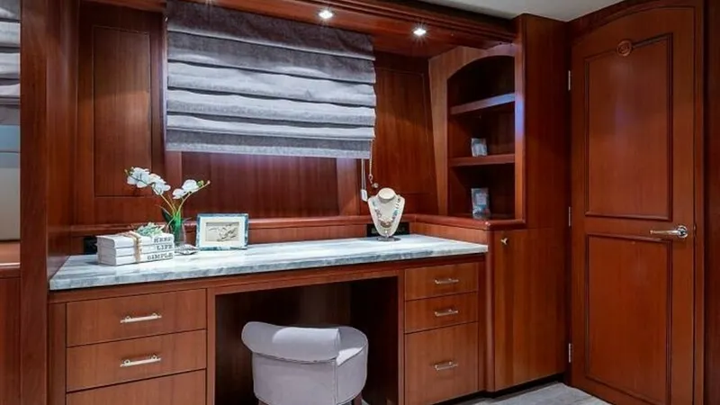Slide: The Image of Elegant Vanity Area with Storage This sophisticated vanity area features rich wood cabinetry and a sleek marble countertop, offering both style and ample storage. The integrated shelving and multiple drawers provide practical space for personal items, while the soft lighting enhances the - 6388395