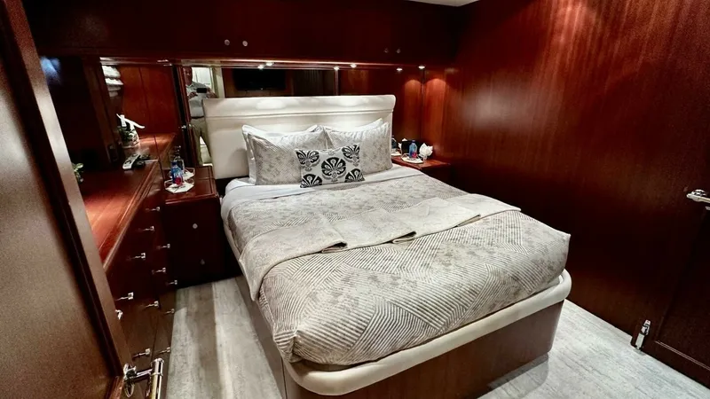 Slide: The Image of Luxurious Guest Stateroom This elegant guest stateroom features rich wood paneling and a plush double bed, creating a cozy yet sophisticated atmosphere. Ample storage is provided by the built-in cabinetry, while soft, ambient lighting enhances the warm tones of the room. The high- - 6388406