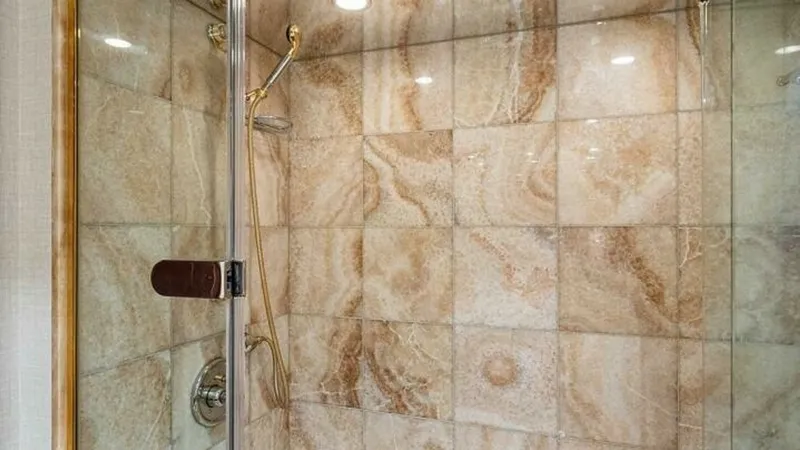 Slide: The Image of Luxurious Marble Shower Enclosure This elegantly designed shower features striking marble tiles that exude sophistication and luxury. The spacious enclosure is equipped with premium fixtures, including a sleek handheld showerhead for a customized bathing experience. Recessed lighting enha - 6388407