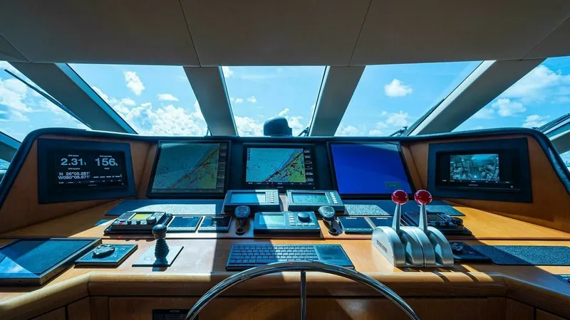 Slide: The Image of Sophisticated Helm Station The helm station of the 2003 Hatteras Magnum Ride features an array of advanced navigational systems and controls. The ergonomic layout includes multiple screens for navigation and monitoring, ensuring precise and safe handling. The expansive windows offe - 6388412