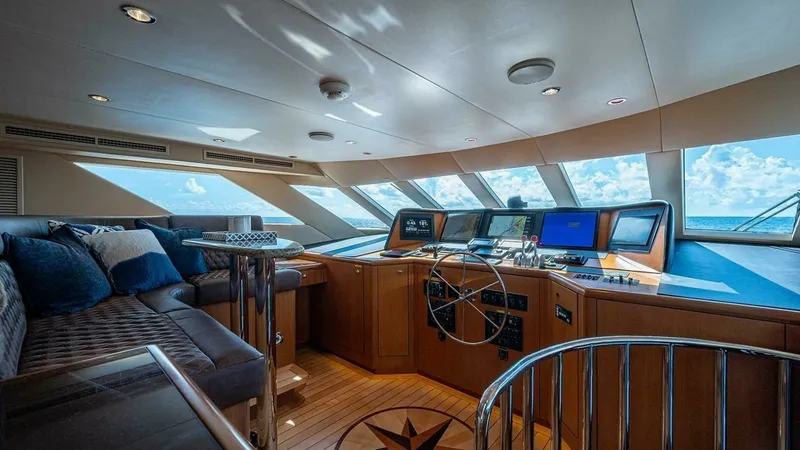 Slide: The Image of Elegant Raised Pilothouse Helm This spacious raised pilothouse features an expansive navigation area with state-of-the-art equipment, ensuring a seamless voyage. The panoramic windows provide stunning ocean views, enhancing the luxurious atmosphere. Comfortable seating with plush cushi - 6388413