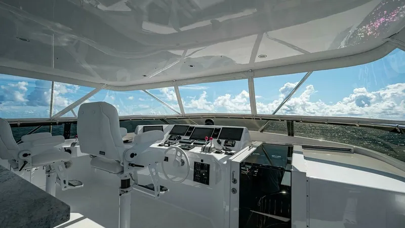 Slide: The Image of Expansive Pilothouse with Ocean Views This spacious pilothouse on the 2003 Hatteras Raised Pilothouse model offers a commanding view of the ocean. Equipped with advanced navigation instruments and comfortable captain's chairs, it ensures a smooth and enjoyable sailing experience. The large wi - 6388418