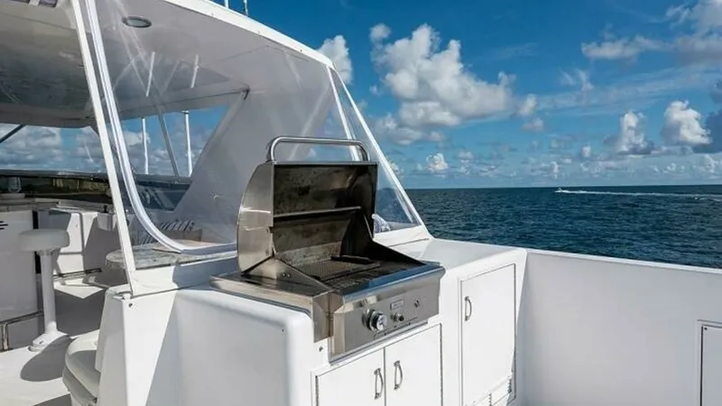 Slide: The Image of Aft Deck with Built-In Grill This spacious aft deck features a built-in stainless steel grill, perfect for outdoor entertaining. The area is complemented by sleek cabinetry for convenient storage, all set against the backdrop of stunning ocean views. The clear protective enclosure of - 6388430