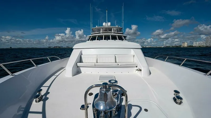 Slide: The Image of Spacious Forward Deck with Seating The forward deck of the 2003 Hatteras Raised Pilothouse showcases a pristine seating area, perfect for enjoying panoramic ocean views. The sleek, white finish complements the polished stainless steel fixtures, including the robust anchor system. This spac - 6388447