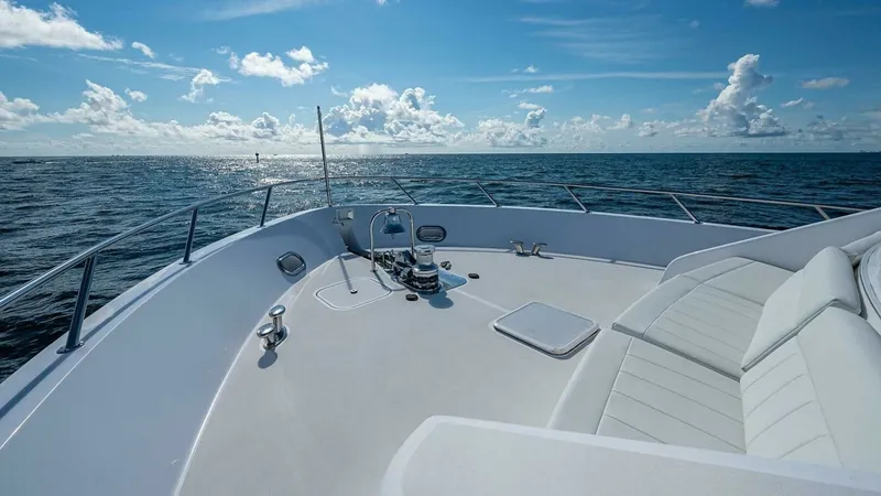 Slide: The Image of Spacious Foredeck with Seating The foredeck of the 2003 Hatteras Magnum Ride showcases an expansive seating area, perfect for lounging and enjoying panoramic ocean views. The elegant design features plush, weather-resistant cushions, complemented by sturdy railings for safety. The area - 6388448