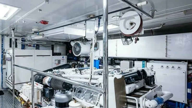 Slide: The Image of Engine Room with Equipment View The engine room of the 2003 Hatteras Raised Pilothouse showcases well-maintained, high-performance machinery. Featuring organized piping and state-of-the-art engines, the space is designed for efficient operation and easy access for maintenance. The brigh - 6388455