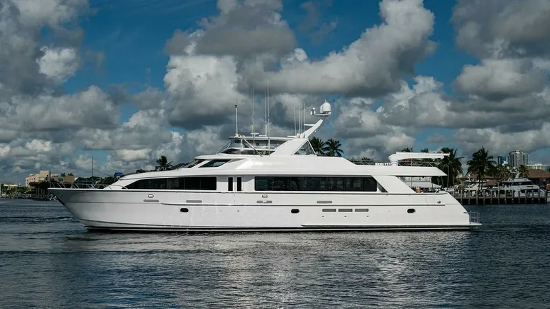 Slide: The Image of Side Profile of Raised Pilothouse This image showcases the sleek side profile of the 2003 Hatteras Magnum Ride, featuring the elegant and commanding structure of the Raised Pilothouse model. The yacht's streamlined design and large windows provide a modern aesthetic and ample natural ligh - 6388461