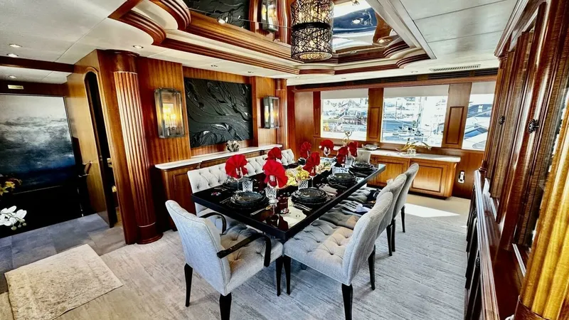 Slide: The Image of Elegant Dining Salon The dining salon of the 2003 Hatteras Raised Pilothouse features a sophisticated setting with a beautifully appointed table and plush seating for eight. Rich wood finishes and large windows enhance the luxurious ambiance, providing ample natural light and - 6388384