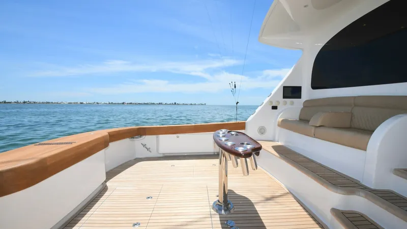 Slide: The Image of Spacious Aft Deck with Seating This 2020 Viking 58 Convertible features a spacious aft deck perfect for both relaxation and fishing activities. The teak flooring adds a touch of elegance, while the built-in seating provides comfort and style. Enjoy panoramic ocean views, making it an i - 6388317