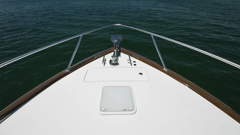 Slide: The Image of Bow Deck with Anchor System The Viking 58 Convertible's bow deck features a sleek, unobstructed design with a robust anchor system at the forefront, offering both functionality and style. The polished stainless steel railing enhances safety while providing a clear view of the open s - 6388322