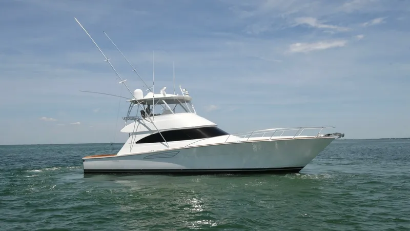 Slide: The Image of Starboard View of Viking 58 Convertible This image showcases the sleek starboard profile of the 2020 Viking 58 Convertible. The yacht's elegant hull design and spacious flybridge are highlighted, offering both luxury and functionality for offshore fishing and cruising. Notable features include - 6388324