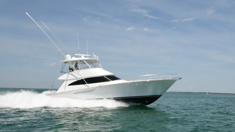 Slide: The Image of Viking 58 Convertible at Sea The Viking 58 Convertible cuts through the water with its sleek, aerodynamic design and powerful performance. Its striking white hull and flybridge are complemented by robust fishing outriggers, showcasing its capabilities for both leisure and sport. The - 6388326