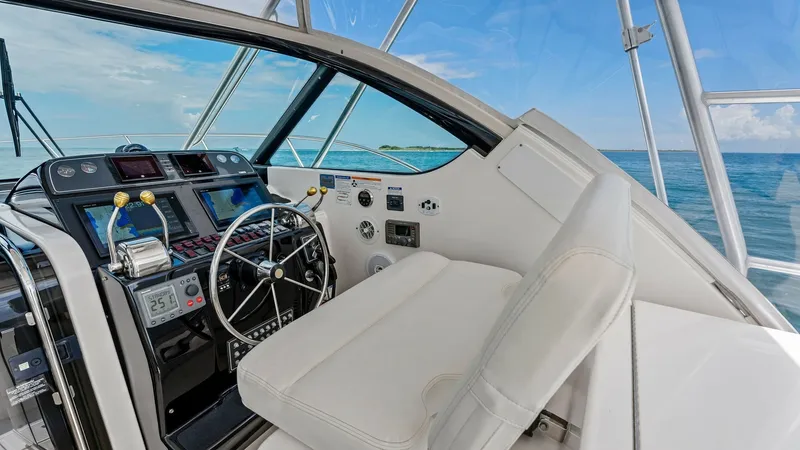 Slide: The Image of Helm Station with Dual Seating The helm station of the 2007 Tiara Yachts 32 Open features a sleek, modern design with a well-equipped dashboard and dual seating. The steering wheel is complemented by a full suite of navigational instruments, ensuring a smooth and informed voyage. Large - 6394569