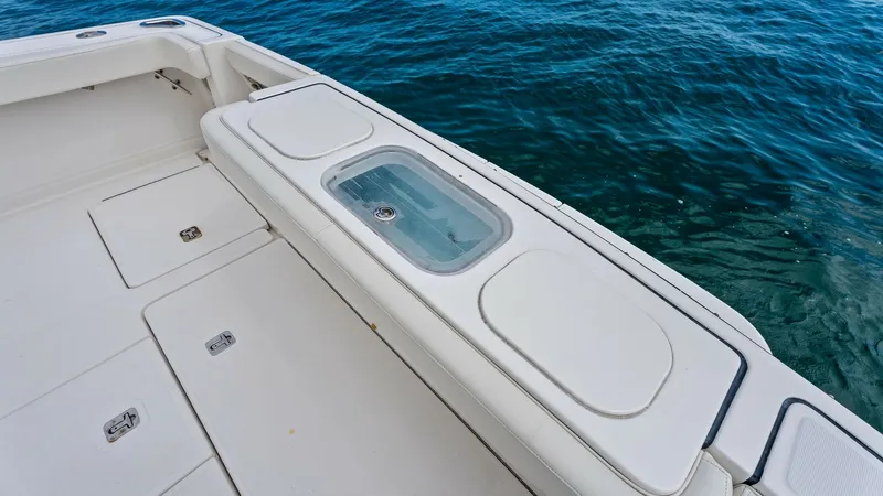 Slide: The Image of Aft Deck with Live Well The aft deck of the 2007 Tiara Yachts 32 Open features a spacious layout with a built-in live well, perfect for fishing enthusiasts. The white non-slip deck provides a safe, comfortable environment for outdoor activities. Ample storage compartments are in - 6394582