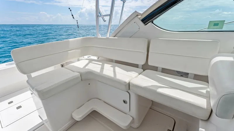 Slide: The Image of Spacious Cockpit Seating Area This inviting cockpit seating area on the 2007 Tiara Yachts 32 Open offers plush, wrap-around seating with high-quality upholstery. Designed for relaxation and enjoyment, the space provides ample room for guests to enjoy the scenic ocean views. The seatin - 6394584