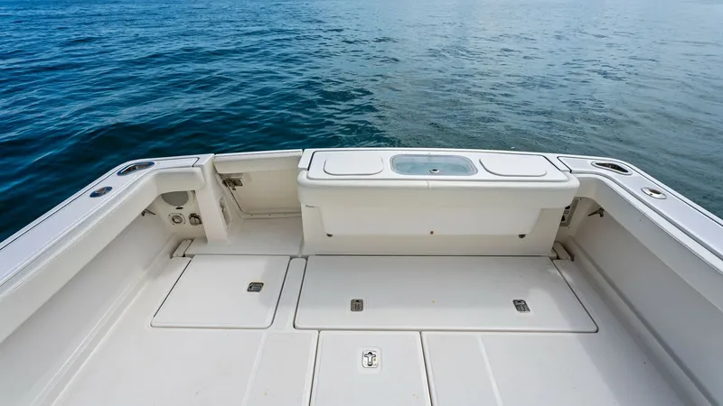 Slide: The Image of Spacious Aft Deck with Storage This image showcases the expansive aft deck of the 2007 Tiara Yachts 32 Open, offering ample space for fishing or relaxation. The deck features integrated storage compartments, perfect for stowing gear or supplies, and a convenient baitwell for fishing en - 6394587