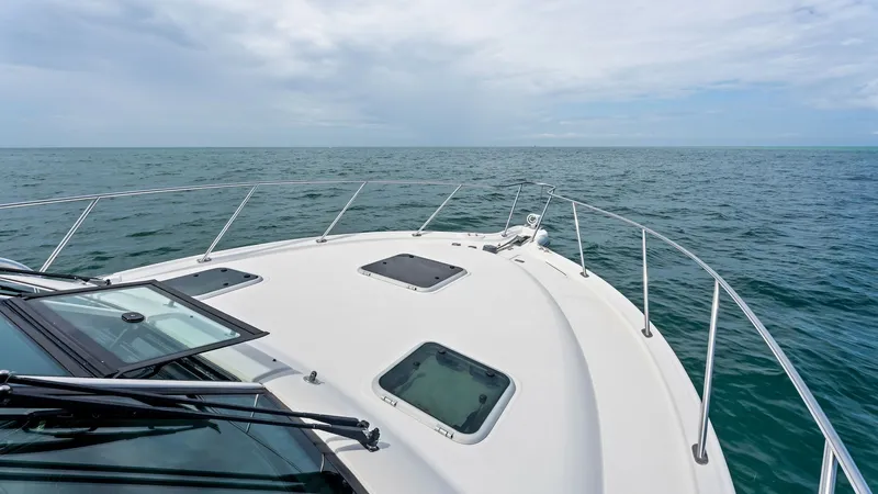Slide: The Image of Forward Deck with Hatches This image showcases the sleek forward deck of the 2007 Tiara Yachts 32 Open, featuring durable hatches for ventilation and light. The stainless steel railing adds safety and style, while the expansive view offers a seamless connection with the open sea. - 6394589