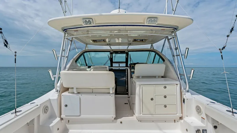 Slide: The Image of Cockpit and Helm Area This image showcases the spacious cockpit and helm area of the 2007 Tiara 32 Open. The cockpit features comfortable seating and well-organized storage compartments, ideal for both cruising and fishing. The helm is equipped with advanced instrumentation an - 6394595