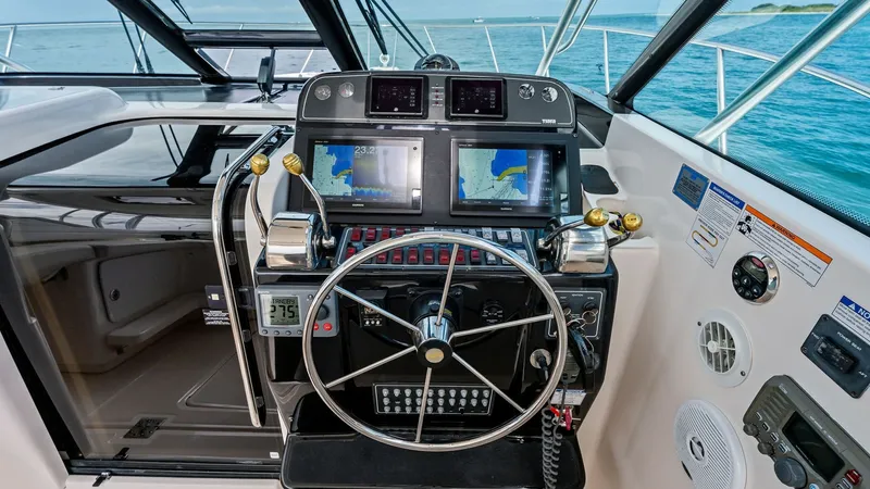 Slide: The Image of Helm Station with Navigation Displays The helm station of the 2007 Tiara Yachts 32 Open features a well-equipped control panel with dual navigation displays and precision instrumentation. The classic steering wheel is complemented by easily accessible throttle controls and modern communicatio - 6394598