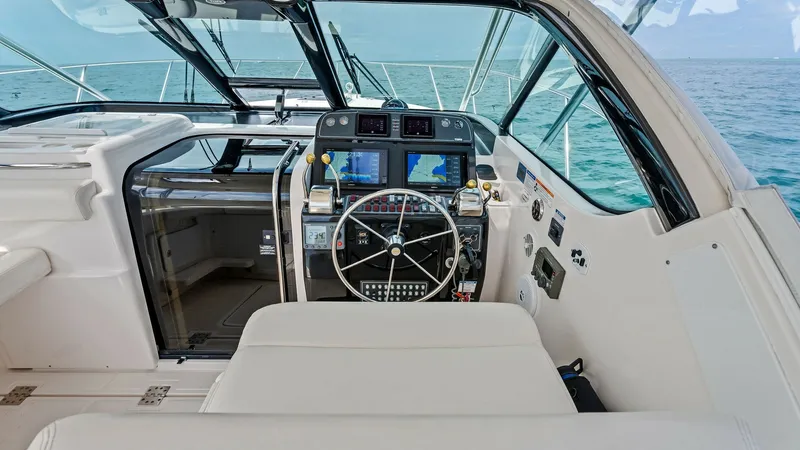 Slide: The Image of Helm Station with Navigation Displays The helm station of the 2007 Tiara Yachts 32 Open showcases an ergonomic design with advanced navigation displays. The plush seating provides comfort, while the expansive windshield ensures excellent visibility. This well-equipped area is ideal for captai - 6394599