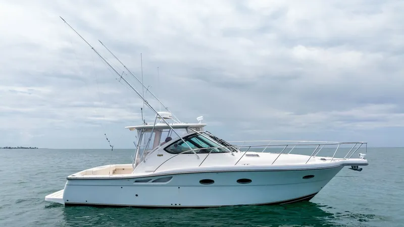 Slide: The Image of Side Profile of Tiara 32 Open This image showcases the sleek side profile of the 2007 Tiara 32 Open, highlighting its elegant lines and robust construction. The vessel features a spacious cockpit with ample seating, perfect for both leisure and fishing activities. The distinct hardtop - 6394601