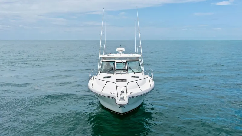 Slide: The Image of Bow View on Open Water This image showcases the sleek bow of the 2007 Tiara Yachts 32 Open, gracefully cutting through the tranquil sea. The vessel's robust design is highlighted by its clean lines and well-crafted railing, offering both elegance and safety. The expansive ocean - 6394602