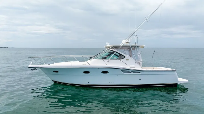 Slide: The Image of Starboard Profile View in Open Water This image showcases the sleek starboard profile of the 2007 Tiara Yachts 32 Open, named 'Second Chance.' The vessel is elegantly cruising in open waters, highlighting its classic lines and robust construction. The spacious cockpit and well-appointed helm - 6394604