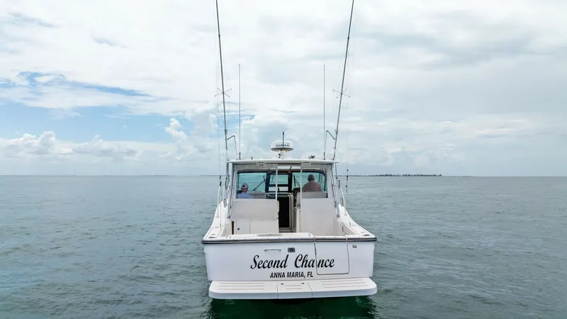 Slide: The Image of Aft View with Fishing Setup This image showcases the aft deck of the 2007 Tiara Yachts 32 Open, 'Second Chance'. The spacious deck is equipped with fishing rods, ideal for deep-sea fishing enthusiasts. The vessel's name and homeport are elegantly displayed, adding a personalized tou - 6394607